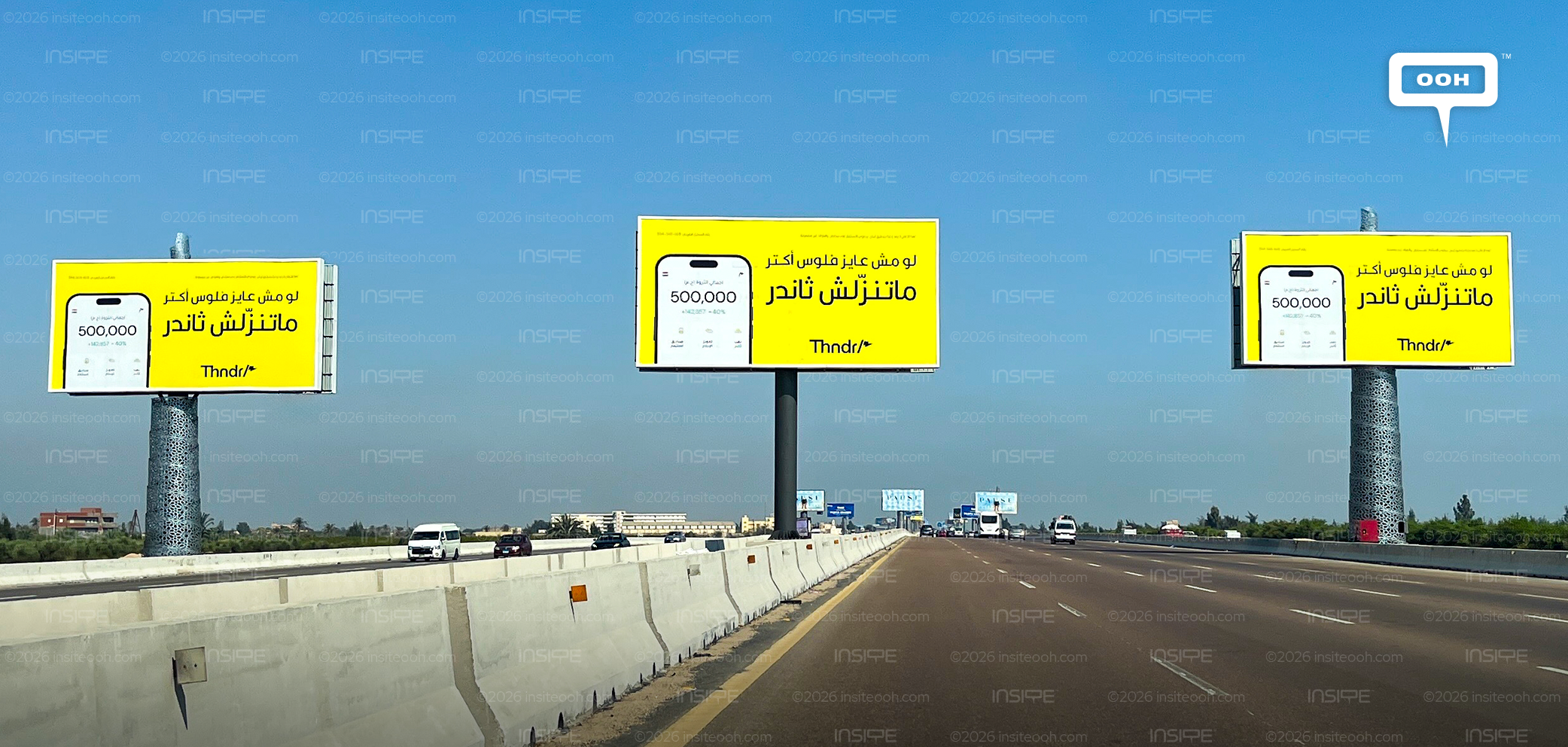 Thndr yellow teaser billboards with Arabic copy lining the North Coast road