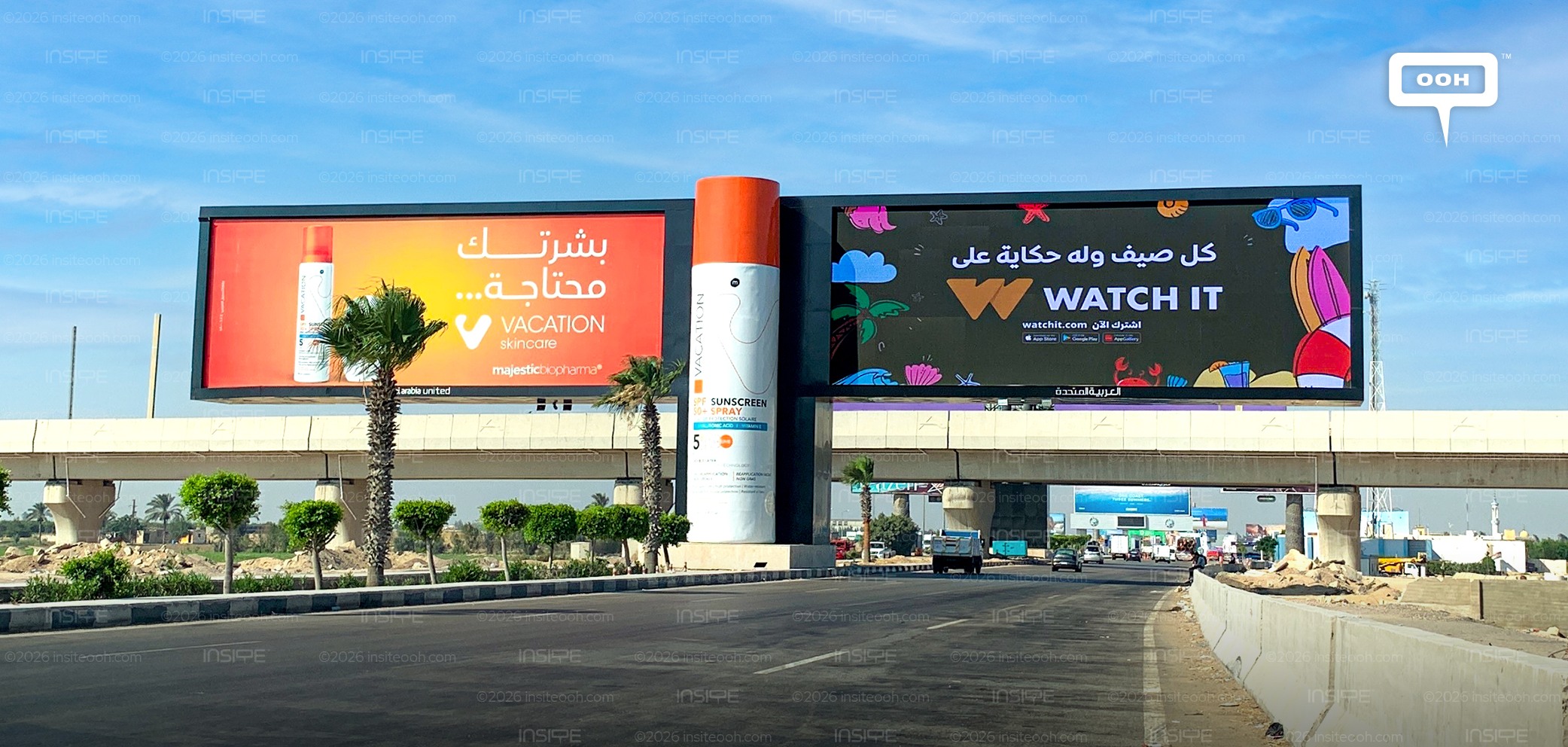 Majestic BioPharma Vacation skincare billboard in Arabic with an oversized 3D sunscreen bottle, beside a Watch It campaign